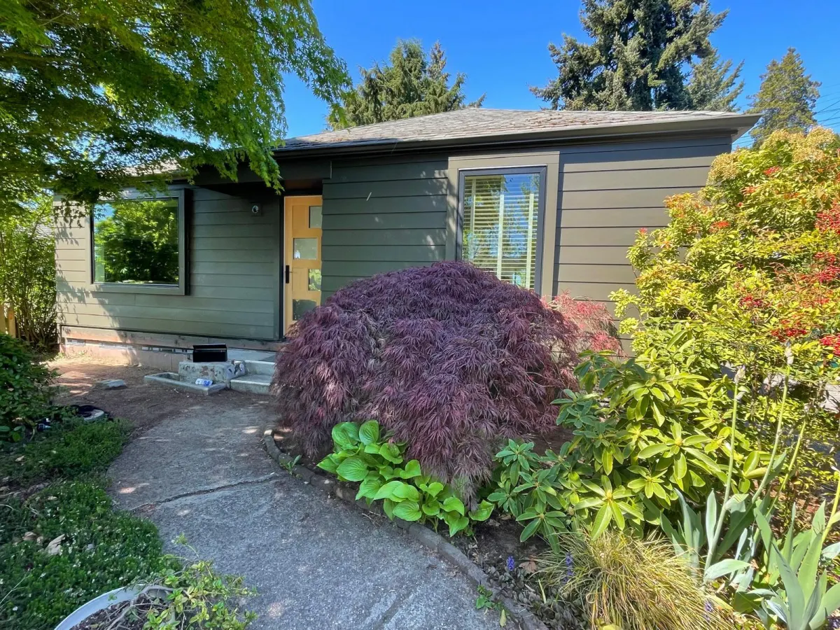 Finished front exterior with fresh paint and landscaping